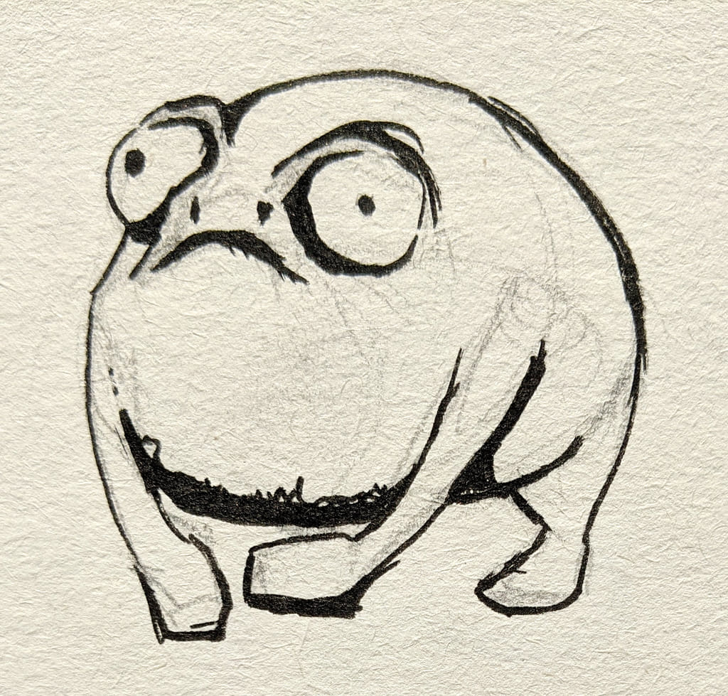 A funny failed sketch done in black ink on textured paper, depicting a very round frog. The creature has uneven, bulging eyes and a wide, wobbly frown, giving it a vacant, spaced out look rather than the intended angry expression.