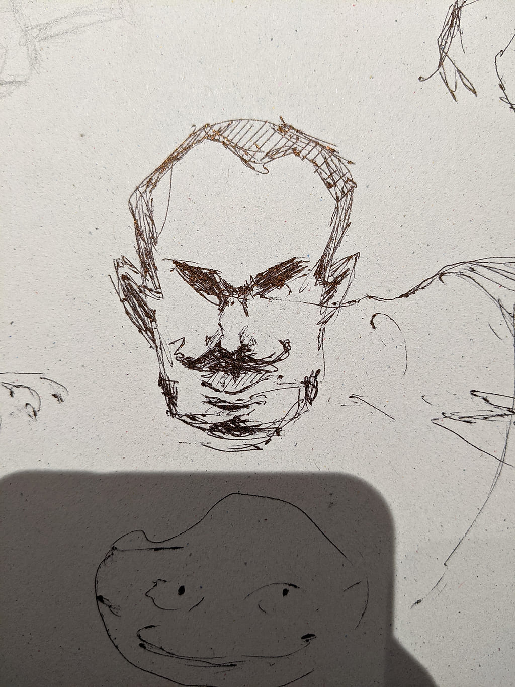 A page of quick black pen sketches with some funny faces.